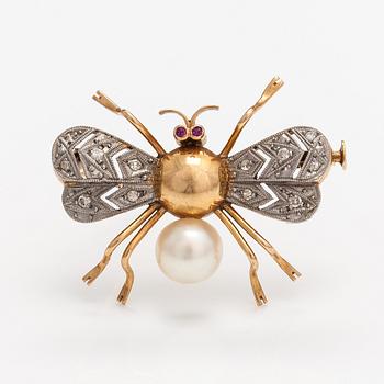 A 15-17K gold brooch with rubies, a cultured pearl and diamonds ca. 0.10 ct in total.