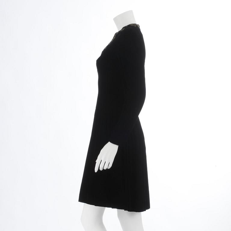 OSCAR DE LA RENTA, a black velvet dress with beading.
