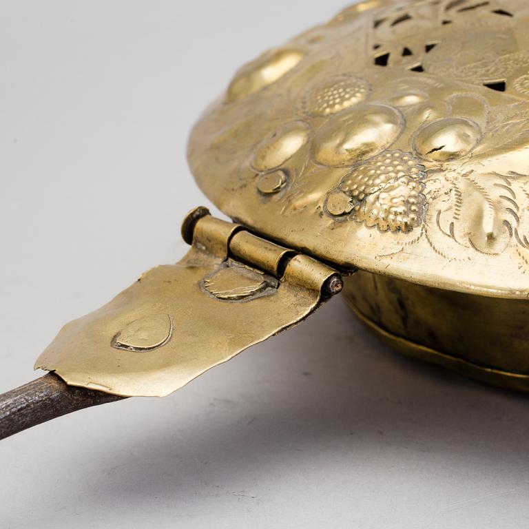 An 18th century brass bed warmer.