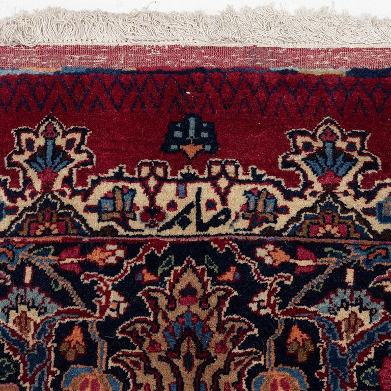 A Mashad carpet, signed Saber, c. 468 x 348 cm.