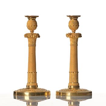 A pair of Empire early 19th century candlesticks.