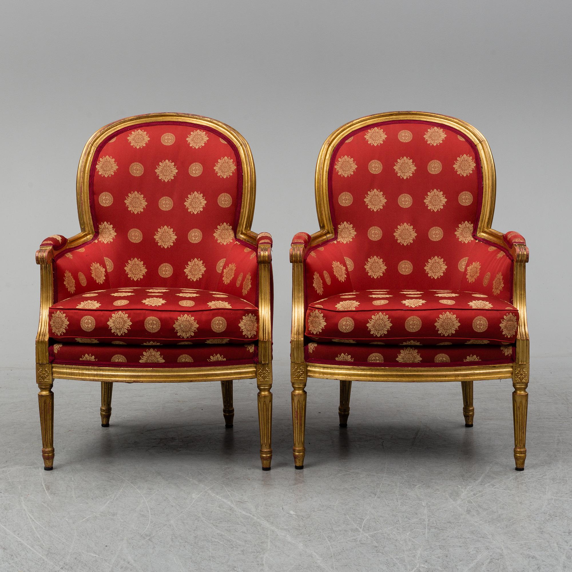 A pair of Louis XVI-style armchairs.