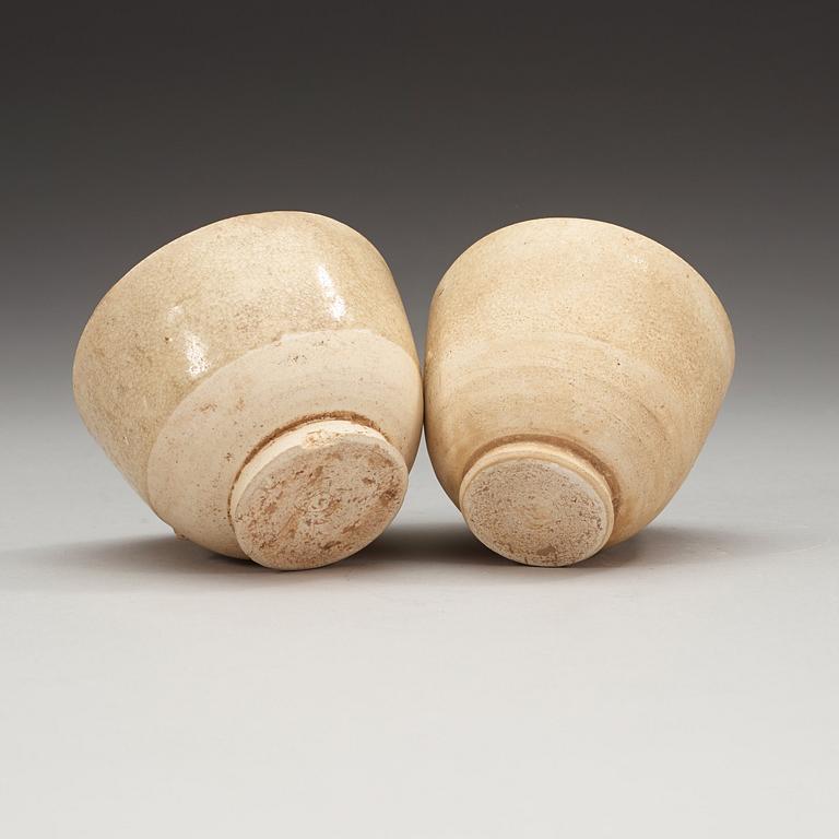 Two white-glazed pottery wine cups, presumably Tang dynasty (618-907).