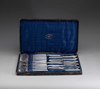 A Russian set of 24 silver fish forks and knivs, makers mark of Mikhail Grachev, St. Petersburg 1908-1917.
