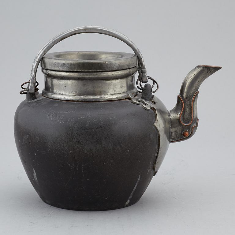 A Chinese pewter teapot with cover and a porcelain dish, 19th and 20th century.