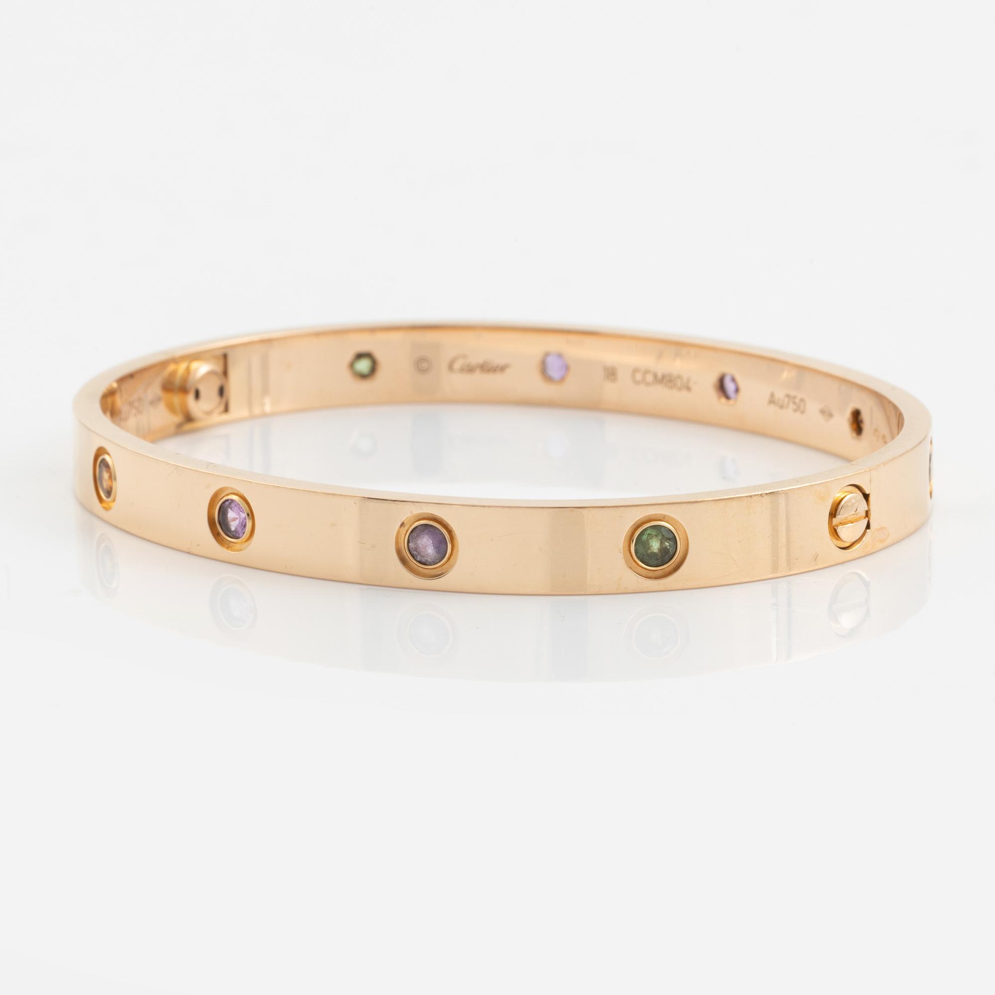 A Cartier "Love" bracelet in 18K rose gold set with colored stones.