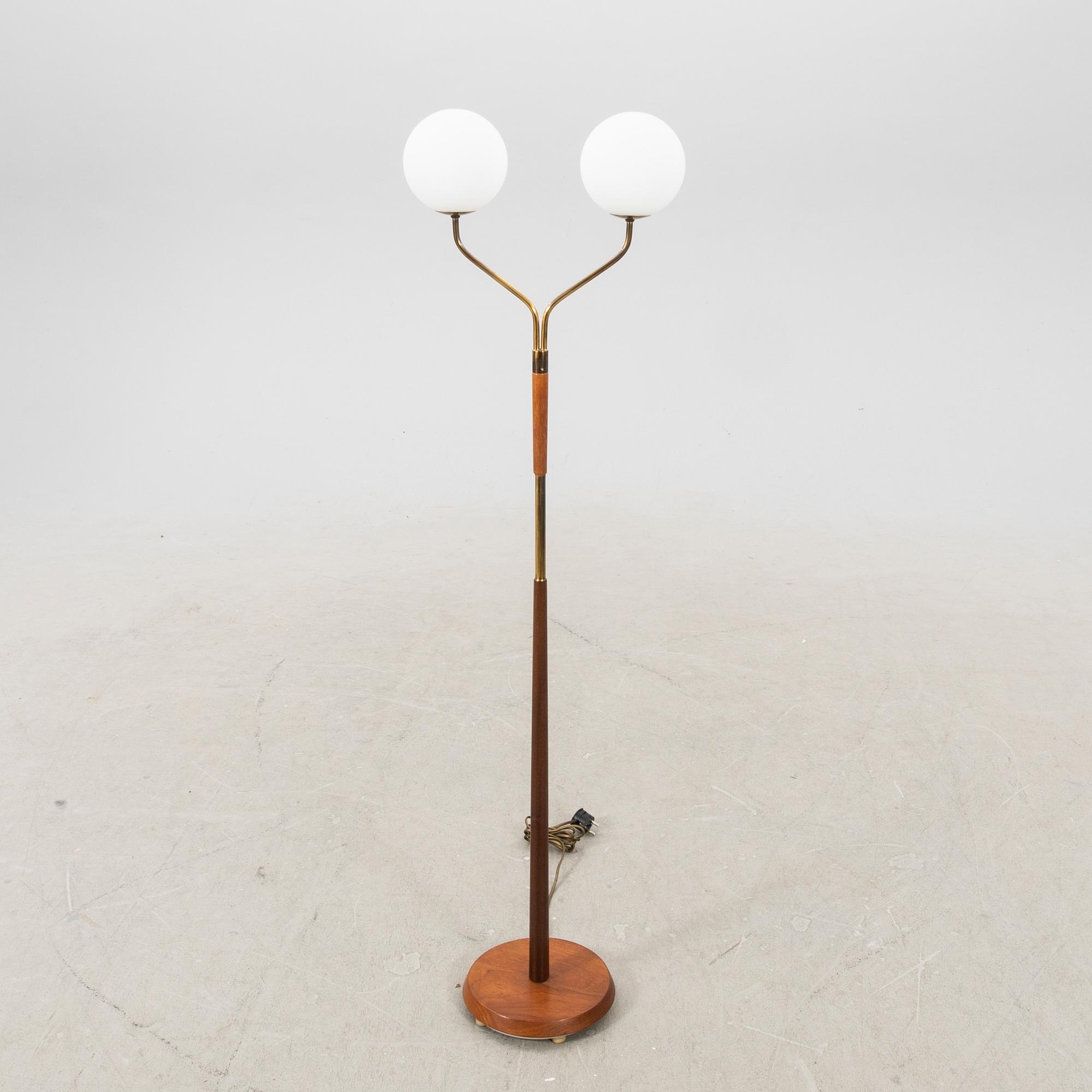 A mid 20th century teak and brass floor lamp.