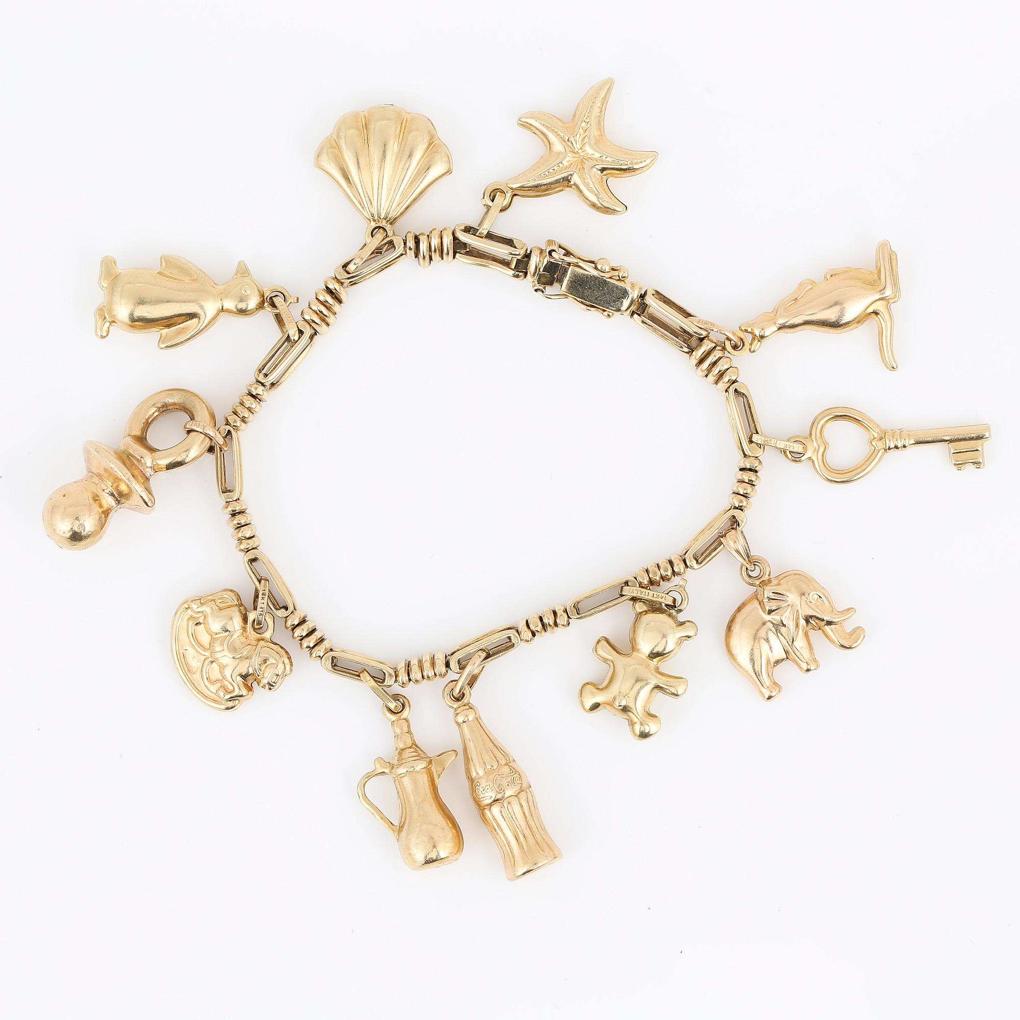 ARMBAND, 14K guld med 11 berlocker, Italien, olika guldhalter, 1900-talets sista kvartal. Vikt ca 26,45 g.