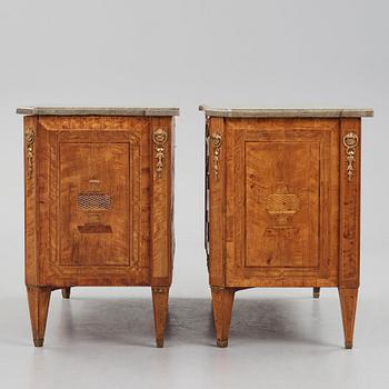 A matched pair of Gustavian ormolu-mounted limestone topped and marquetry commodes by C. Lindborg, late 18th century.