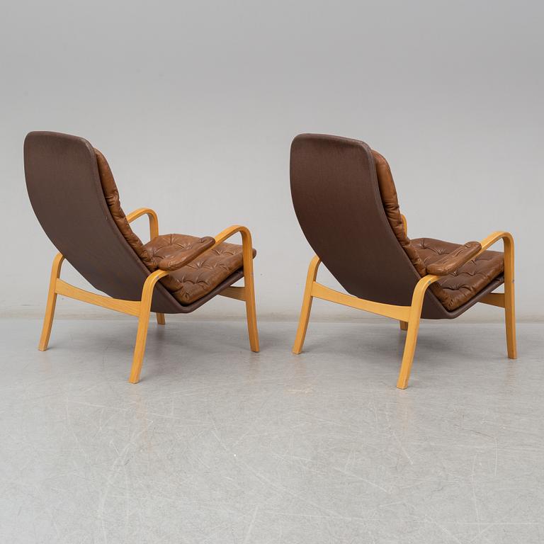 A pair of 1970's 'Mona' armchairs by Sam Larsson for Dux.