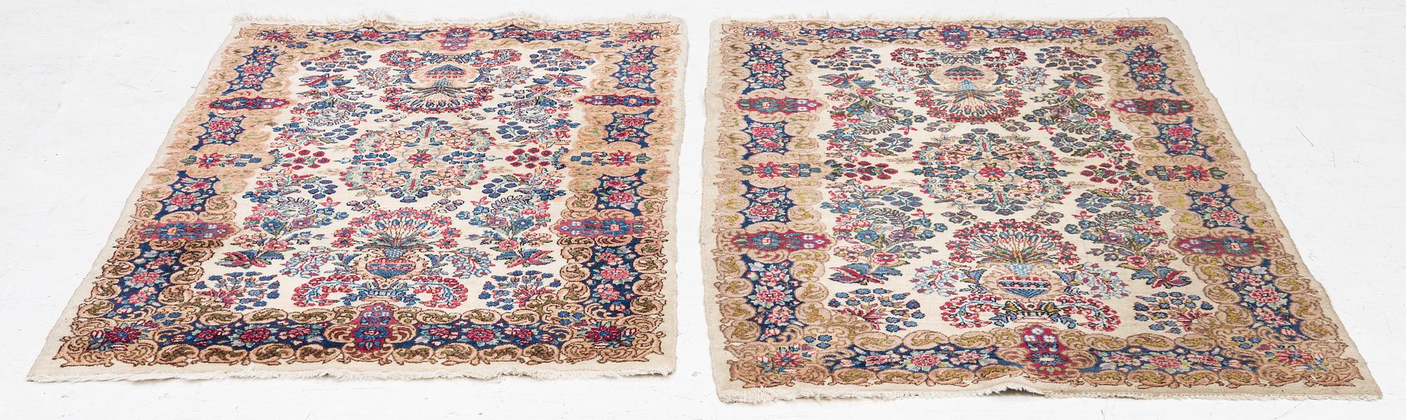 A pair of similar Kirman rugs, south Persia, c. 147 x 94 and 154 x 96 cm.