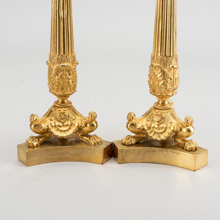 A pare of late empire candelsticks mid 19th century.