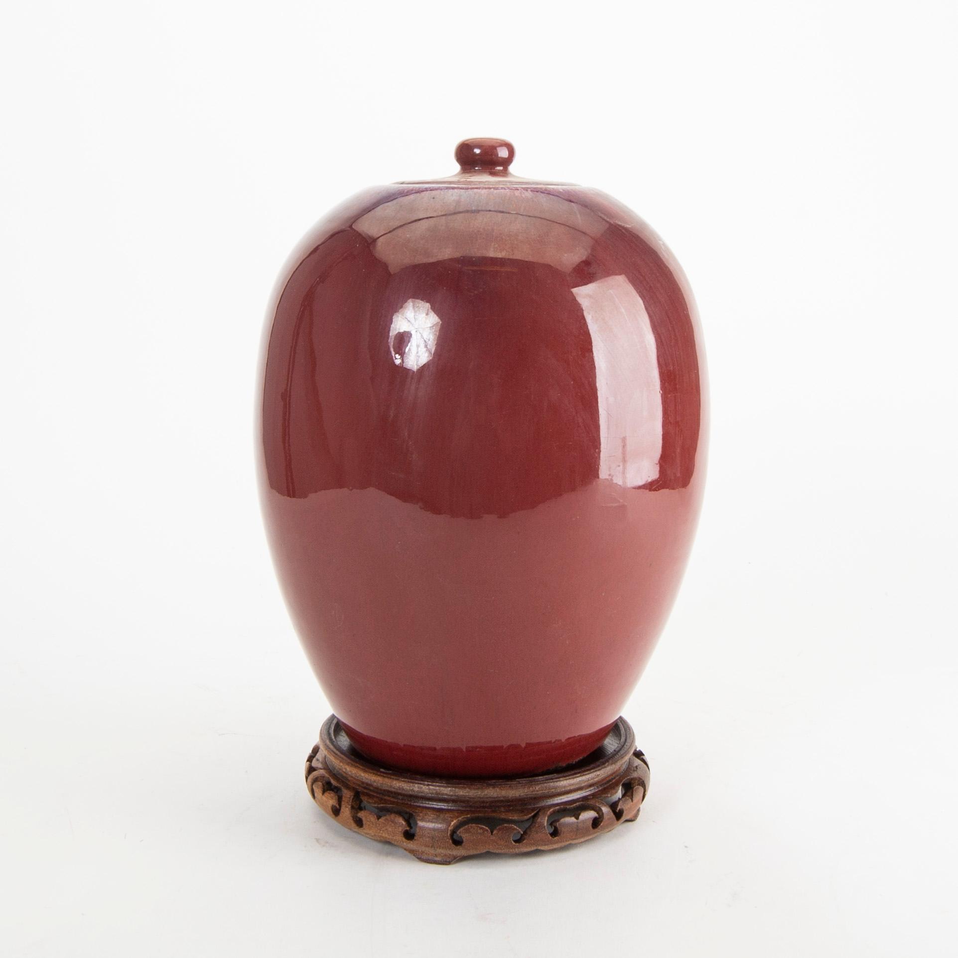 A sang de boef/flambe glazed jar with cover, Qing dynasty, circa 1900.