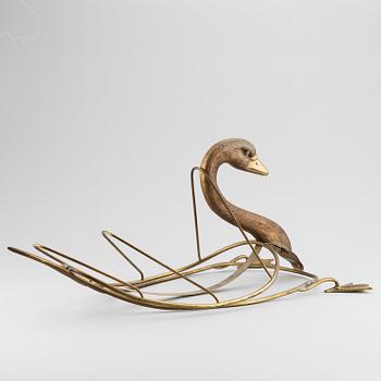 A 20th century grass newspaper stand in the shape of a swan.