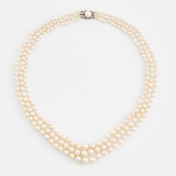 Three strand calibrated cultured pearl necklace, clasp with pearl and rose cut diamonds.