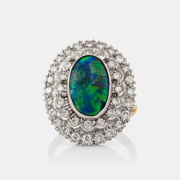 1267. An opal and brilliant-cut diamond ring. Total carat weight circa 0.80 ct.