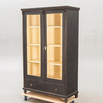 A painted early 1900s display cabinet.