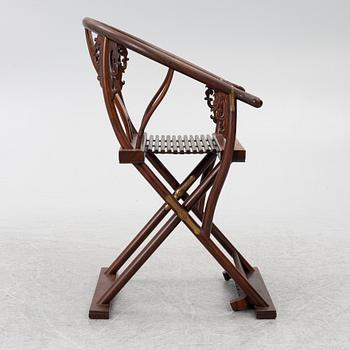 A Chinese hardwood folding chair, 20th century.