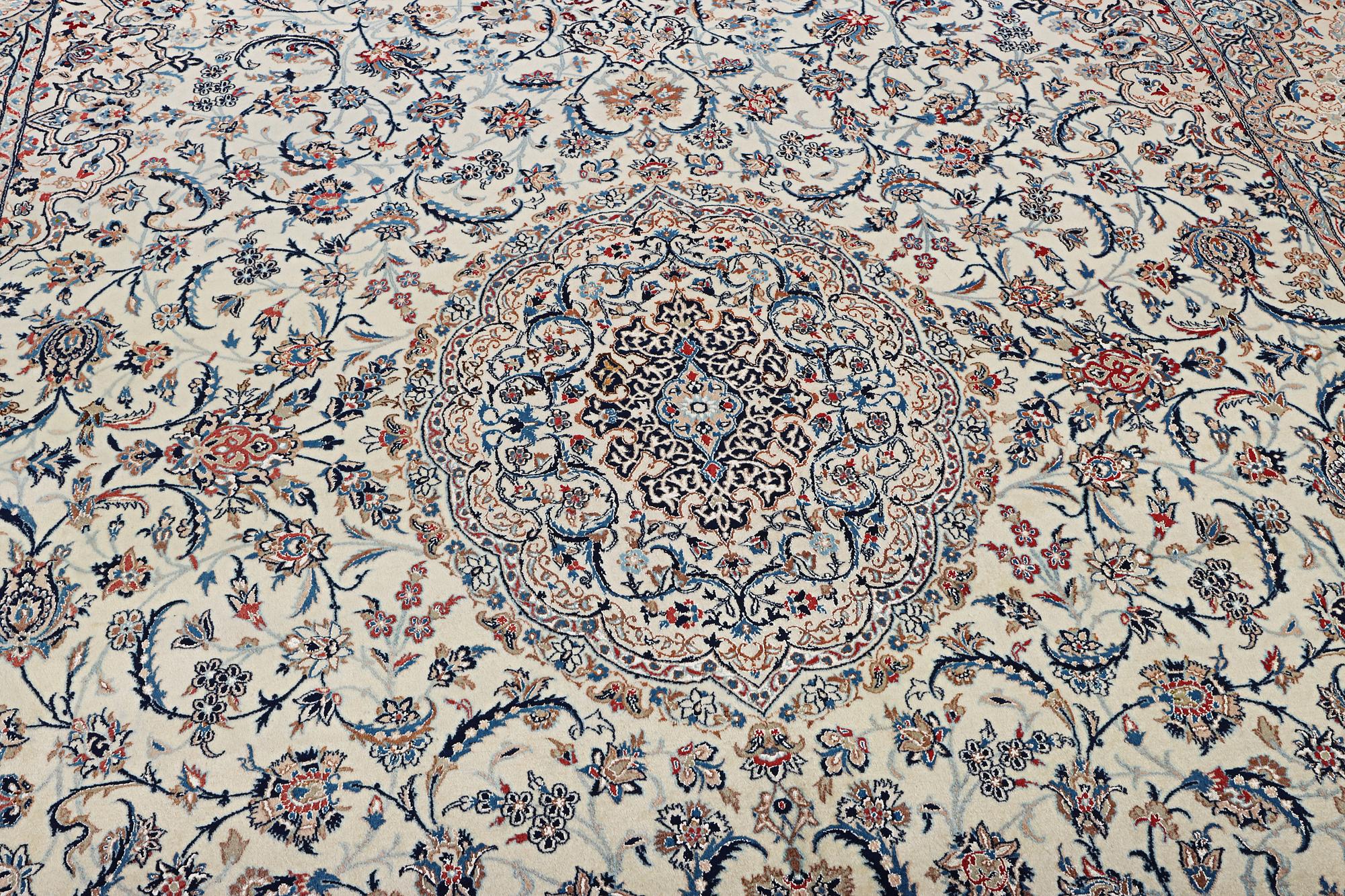 A Nain carpet, part silk, 9 laa, c. 453 x 298 cm.