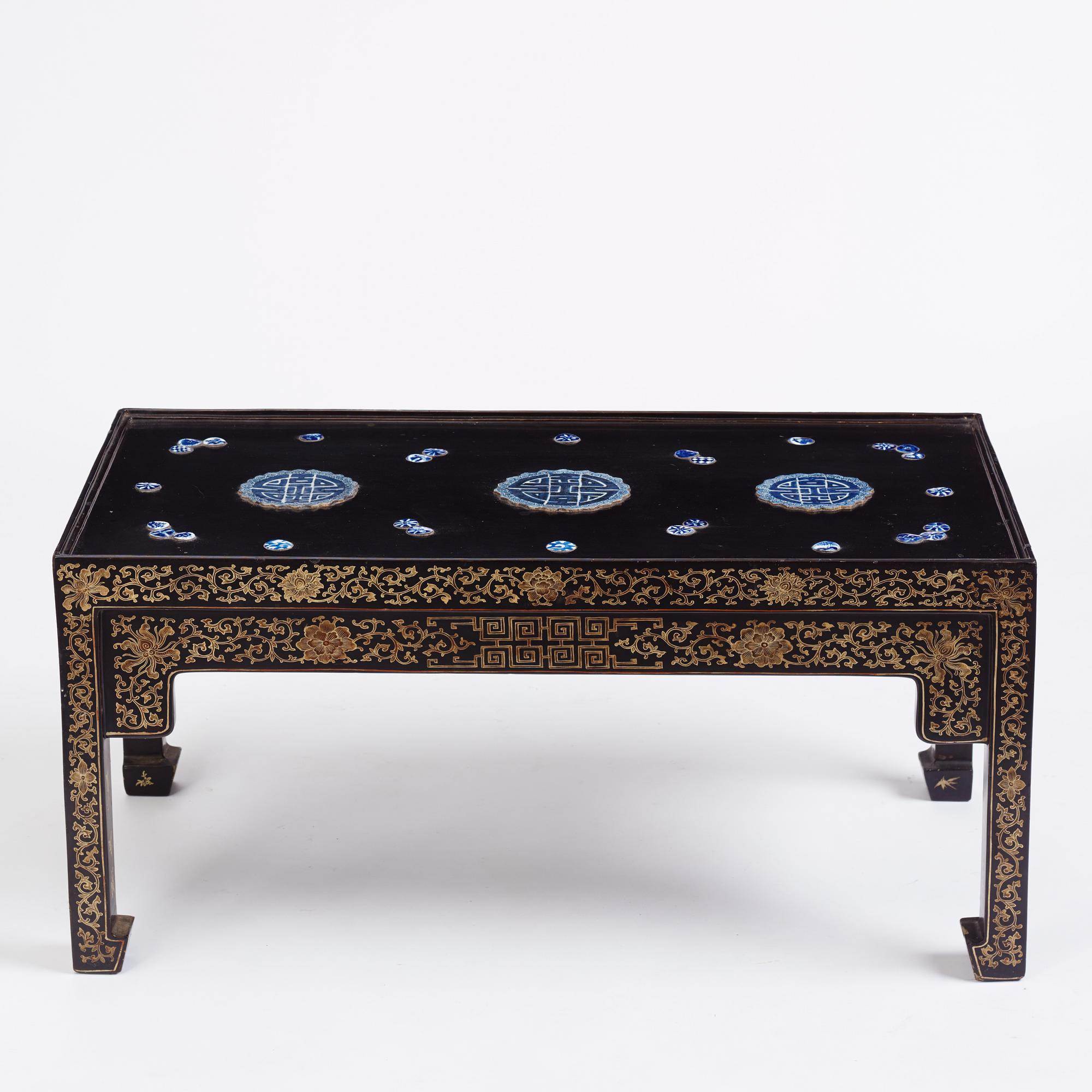 A Chinese black lacquered table with porcelain placques, presumably first half of the 20th century.
