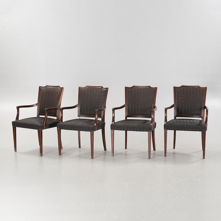 An english style dining table and eight chairs, second half of the 20th century.