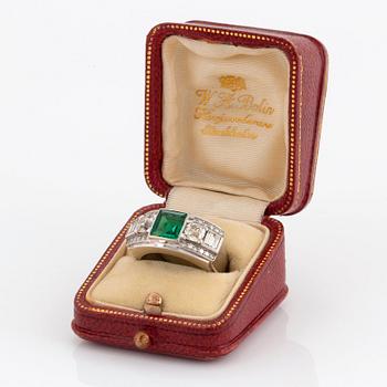 An 18K white gold WA Bolin ring set with a faceted emerald and old-, eight- and baguette-cut diamonds.