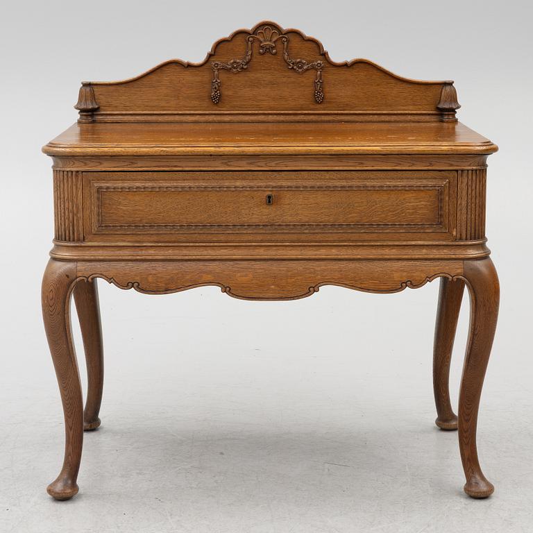 Dining table, 8 chairs, 2 armchairs, sideboard, Rococo style, early 20th century.