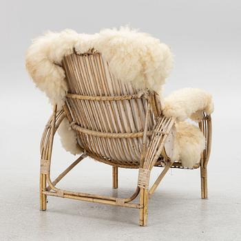 A Scandinavian cane armchair, mid 20th century.