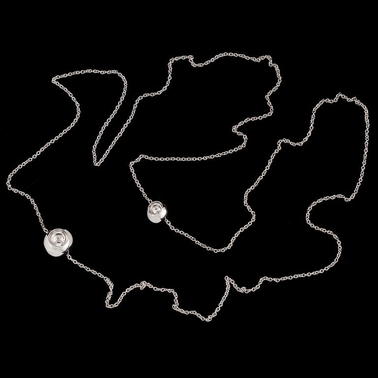 An 18K white gold 'Cave' necklace set with two round, brilliant-cut diamonds by Jacqueline Rabun for Georg Jensen.