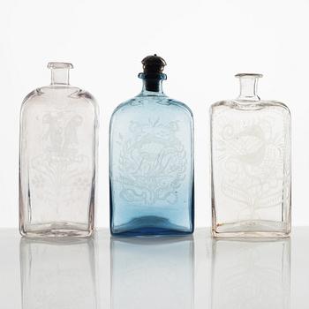 A set of three engraved brandy bottles, partly Cedersbergs glasbruk, 18th/19th century.