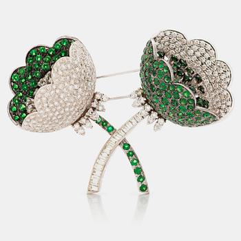 643. A tsavorite garnet and brilliant cut diamond clip brooch with floral motif.