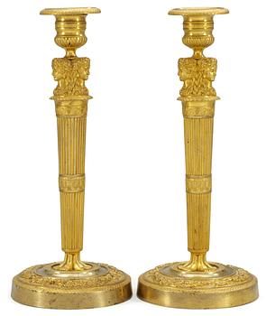 1042. A pair of French Empire candlesticks.
