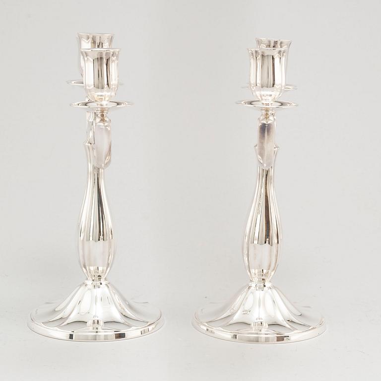 A pair of Swedish silver candelabra, makers mark GAB, Stockholm 1935 and 1938.