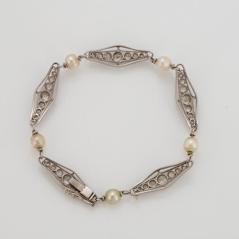 A platinum bracelet set with old-cut diamonds and pearls.