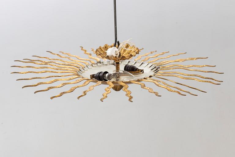 A ceiling lamp in the shape of the sun. Mid 20th century.
