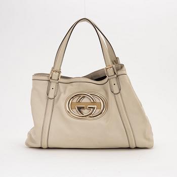 Gucci, a cream leather handbag.