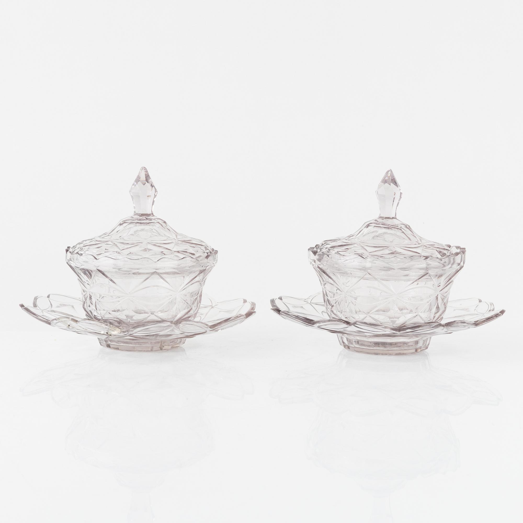 A pair of lidded glass bowls with stands, late 19th century.