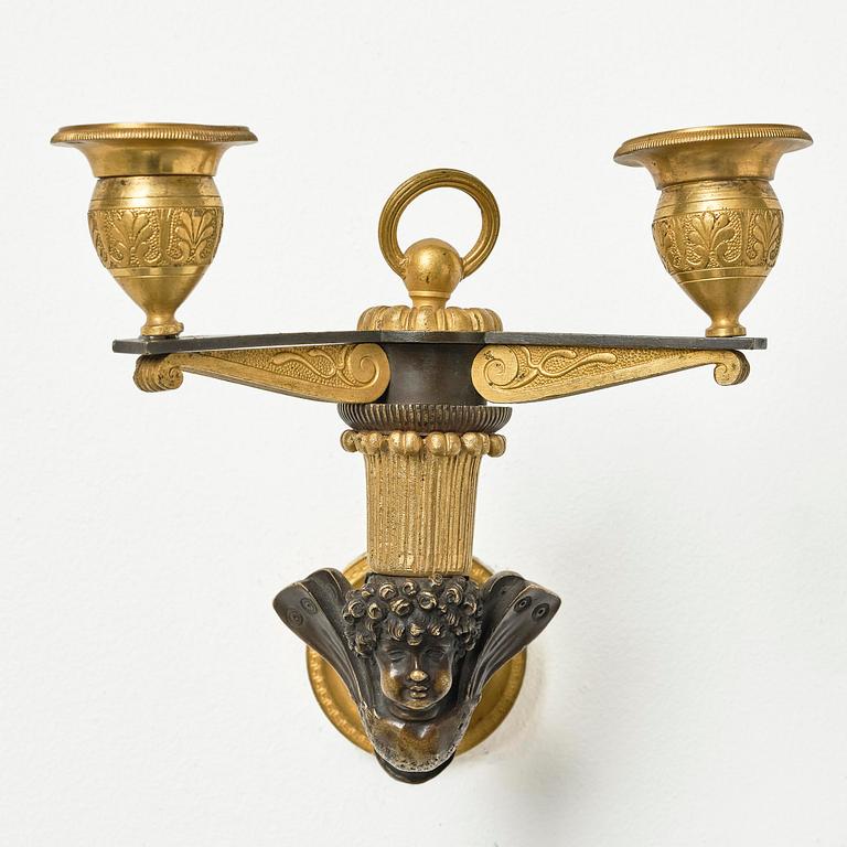 A pair of Empire patinated and ormolu two-branch appliques attr. to C. Galle (bronzier in Paris 1786-1815).