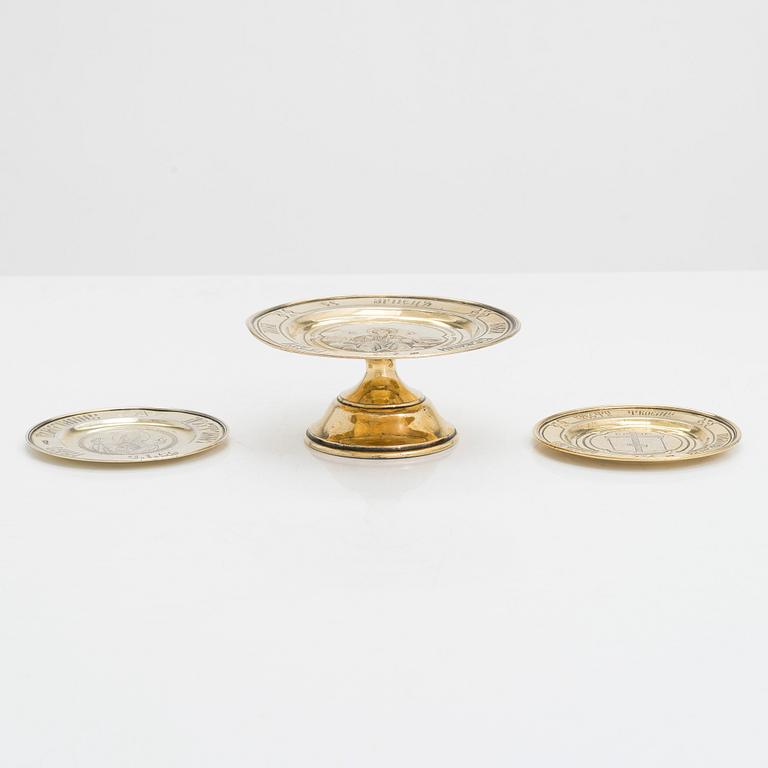 Three 19th-century gilt silver paten, two by master Dmitry Maksimovich Shelaputin, Moscow, 1876-77.