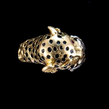 A RING shaped like a leopard with enamel, rubies and brilliant cut diamonds.