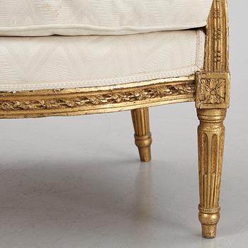 A near pair of French Louis XVI giltwood bergères, Paris, late 18th century.