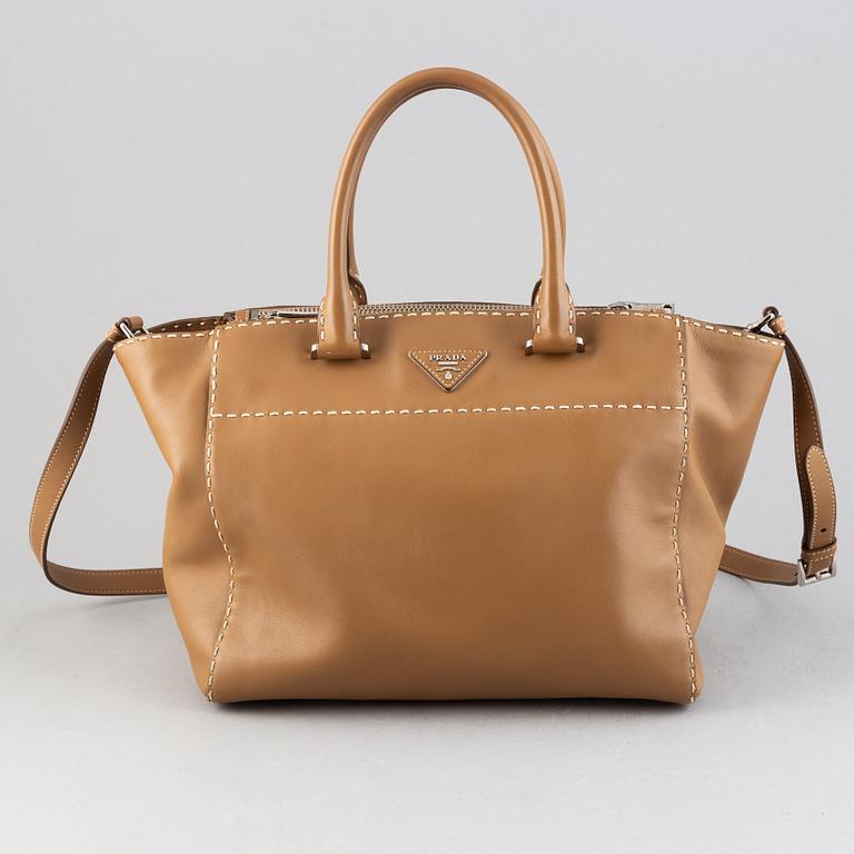Prada, a leather handbag.
