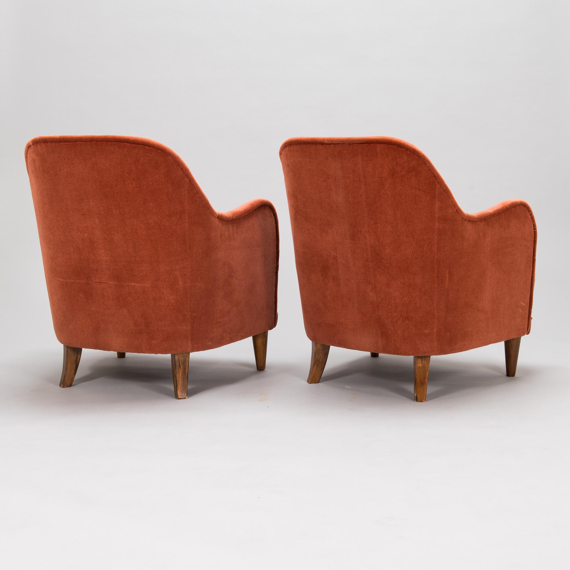 A pair of mid-20th-century armchairs.