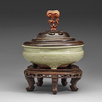 A large tripod celadon censer, presumably late Ming dynasty (1368-1644).