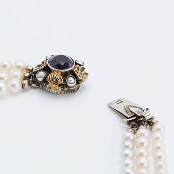 A cultured saltwater pearl collier with silver lock with purple faceted amethyst.
