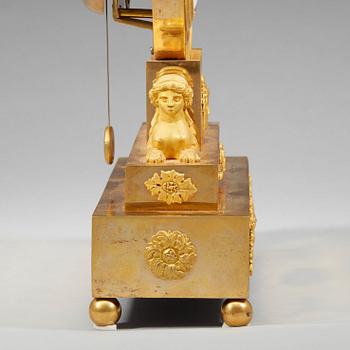 A late Gustavian early 19th century gilt bronze mantel clock.