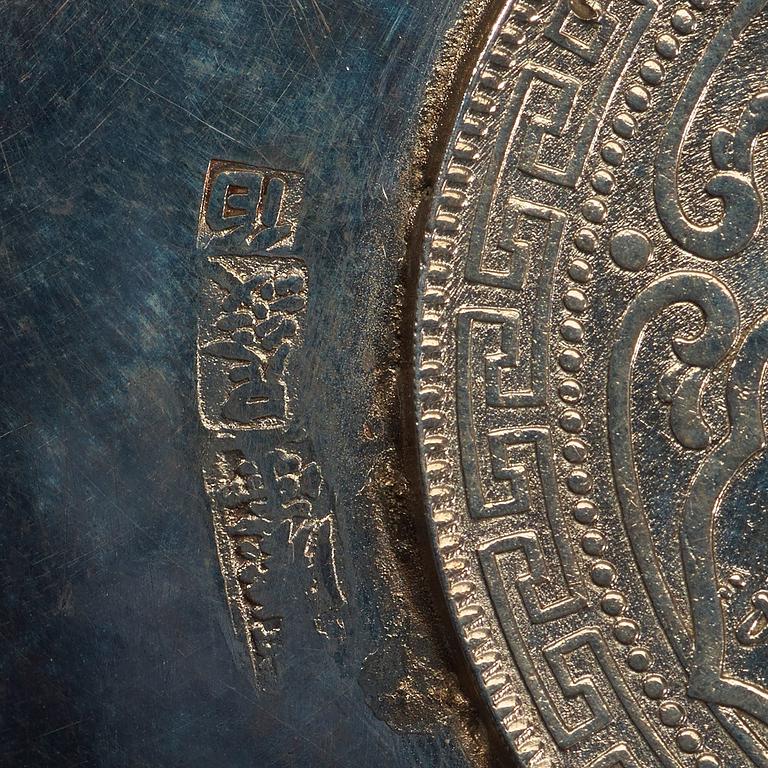 A small silver plate with a One Dollar coin, Qing Dynasty, Guangxu 1899.