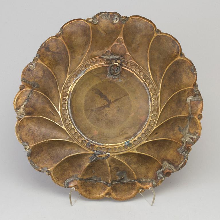 A 17th century brass wall plaque.