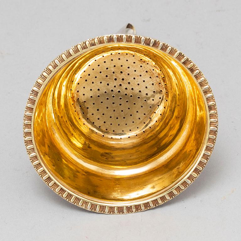 GUSTAF FOLCKER, a parcel-gilt silver strainer, Stockholm 1831.