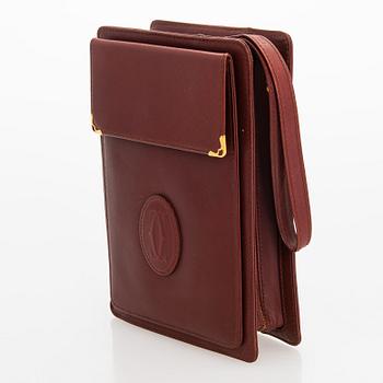 Must de Cartier bag clutch with accessories.